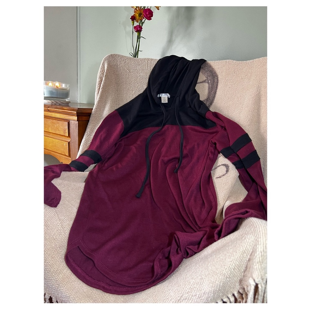 Maroon and black hooded long sleeve shirt. Drawstrings. Two stripes on the arm